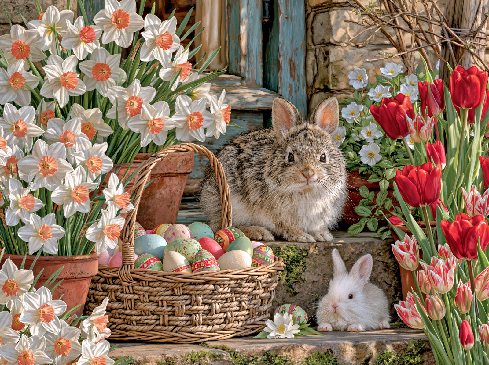 A basket of painted Easter eggs with two rabbits among daffodils and red tulips