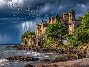 Online jigsaw puzzle - Pictorial of Historic St Andrews Castle crowns the cliffs as gulls soar and dramatic sunlight pierces cloudy skies - picture 11